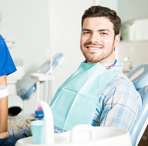 smiling man sitting in a dental chair