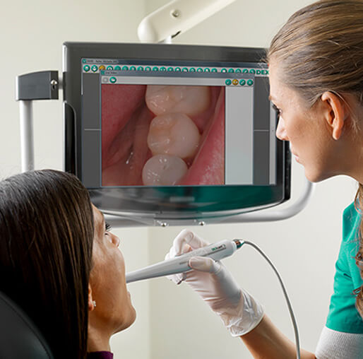 hygienist using an intraoral camera on a patient's mouth