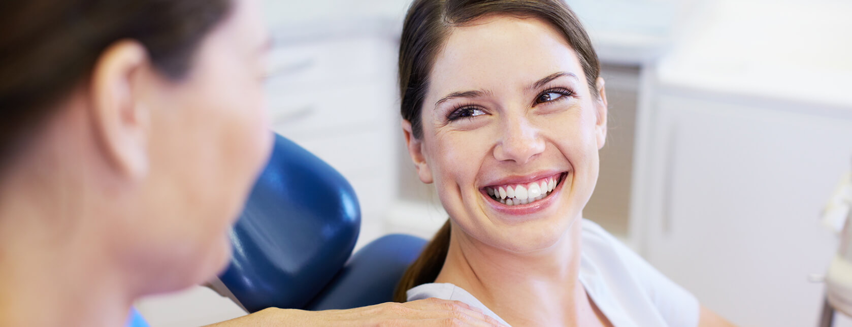 smiling woman sitting in a dental chair