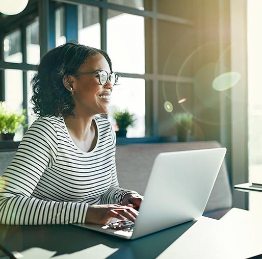 woman smiling at a computer