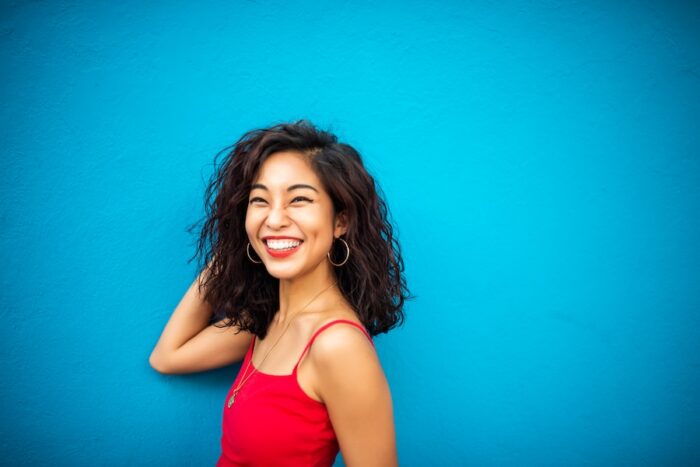 Asian woman smiling after cosmetic dentistry