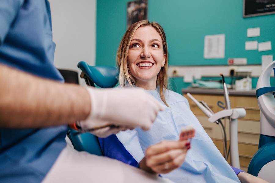 woman getting veneer repaired at dentist